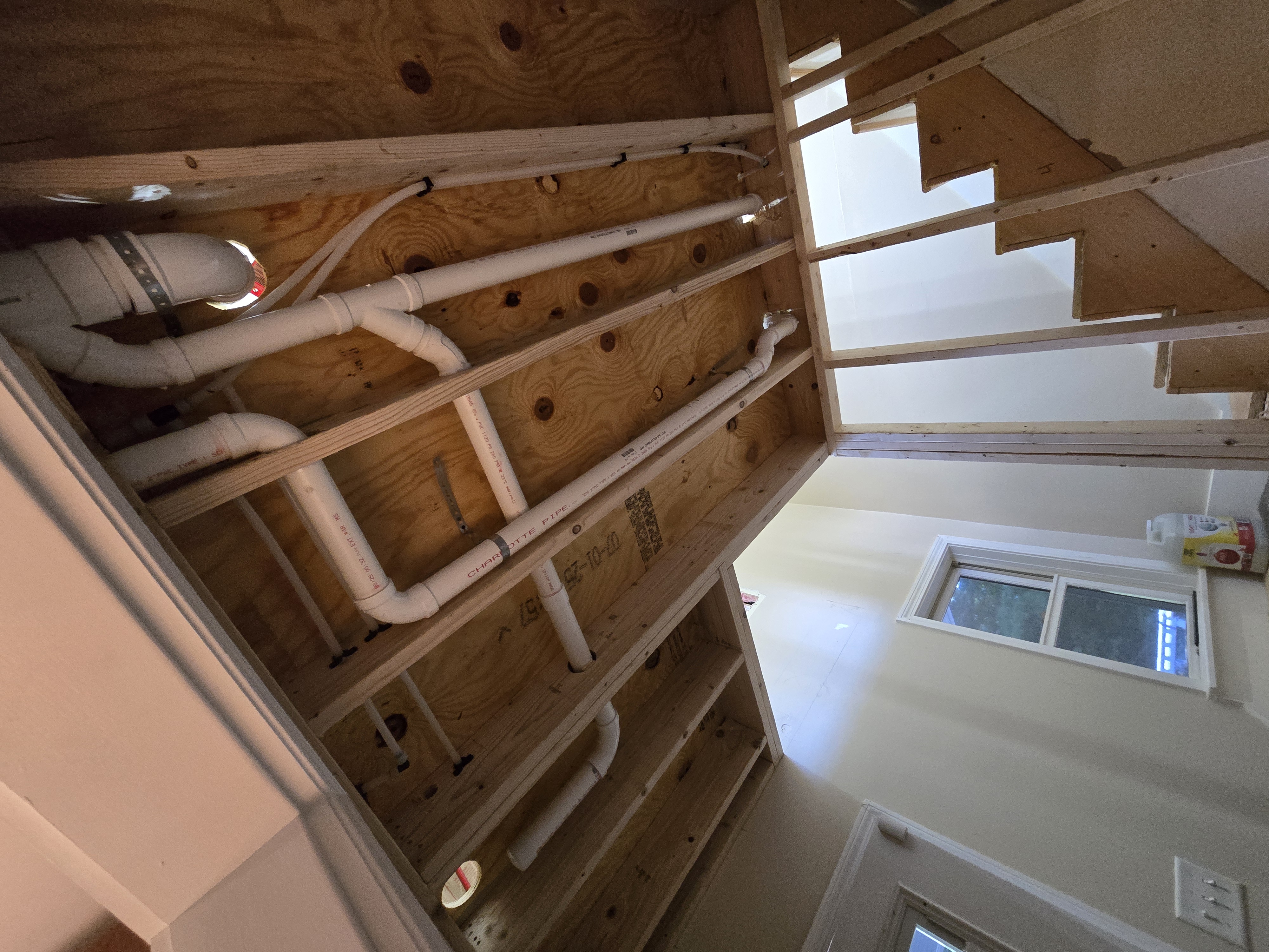 Rough-in drain and vent piping through floor framing
