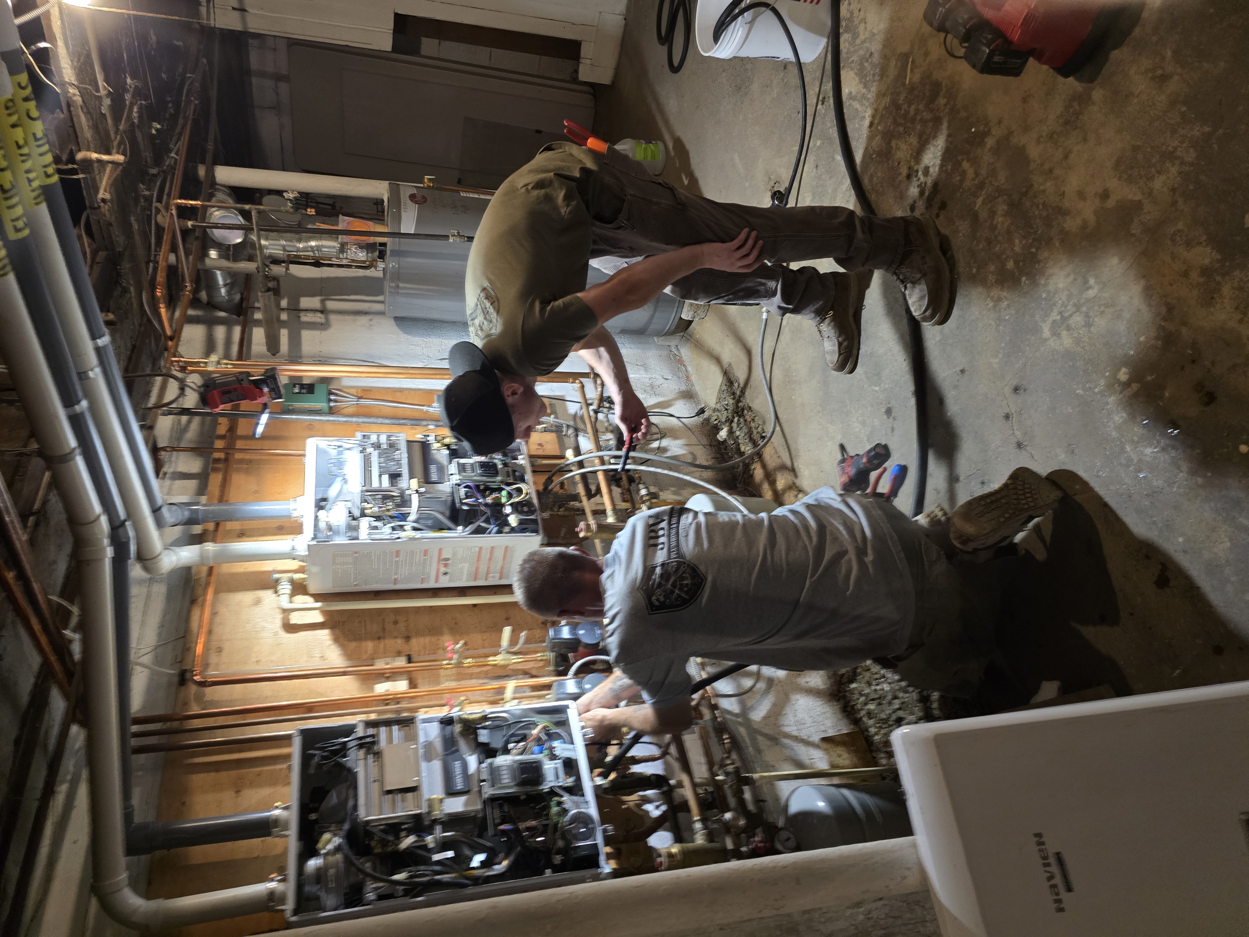 JBV technicians installing twin tankless water heaters